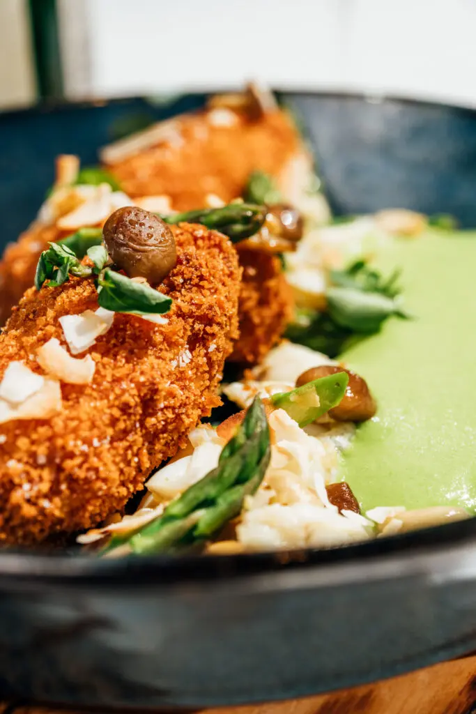 The crab croquettes at Little's Oyster Bar are served with chilled asparagus, pickled cultivated mushrooms, basil, and a coconut sauce inspired by vichyssoise. (Photo by Arturo Olmos)