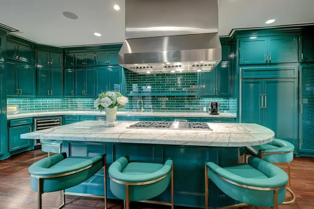 The turquoise coloring of the photos belie the emerald green kitchen in the luxurious 'Tuscan Villa' townhome at 5722 Logan Lane makes an impression, (Photo by TK Images/Compass)