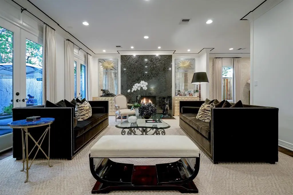 The formal living room with gas fireplace in the luxurious 'Tuscan Villa' townhome at 5722 Logan Lane (Photo by TK Images/Compass)