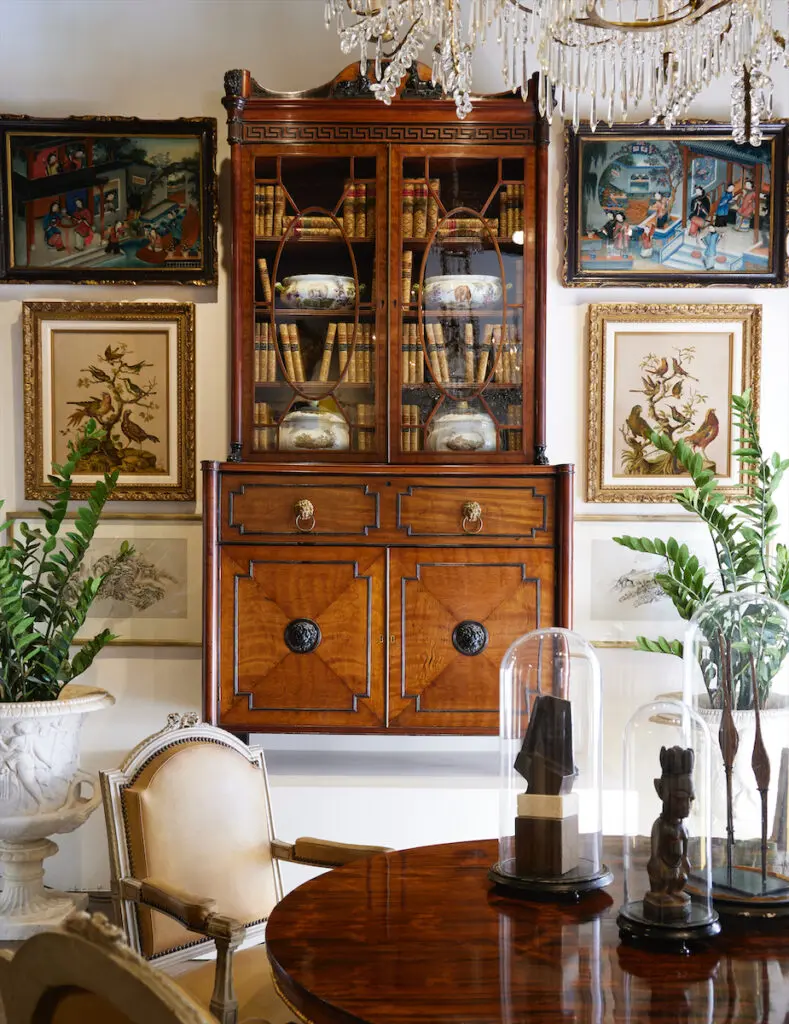 English Regency Sheraton secretary bookcase,
circa 1800; 18th-century Chinese reverse painted
glass pictures; Louis XVI fauteuils, circa 1790. (Photo by Kris Ellis)