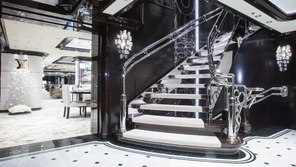 The swirling grand staircase on Tilman Fertitta's superyacht 'Boardwalk' (Photo courtesy of Fertitta Entertainment)