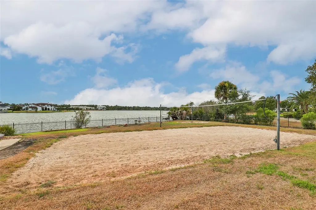 This mansion boasts many fun features, one of which is the beach volleyball court overlooking the lake. 