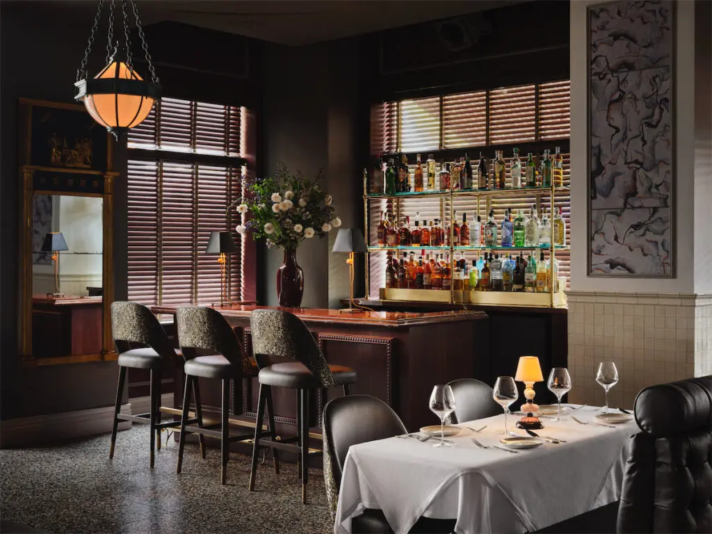 There are several dining rooms at Mister Charles, some offering a dark and moody vibe... (Photo by Douglas Friedman)