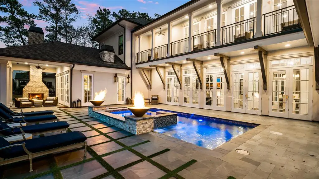 The backyard is made for socializing, with a pool, jacuzzi spa and comfy seating areas. 