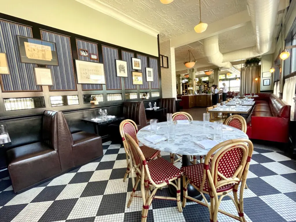 Café chairs mix with banquettes of wine red and chocolate brown. (Photo by Courtney Dabney)
