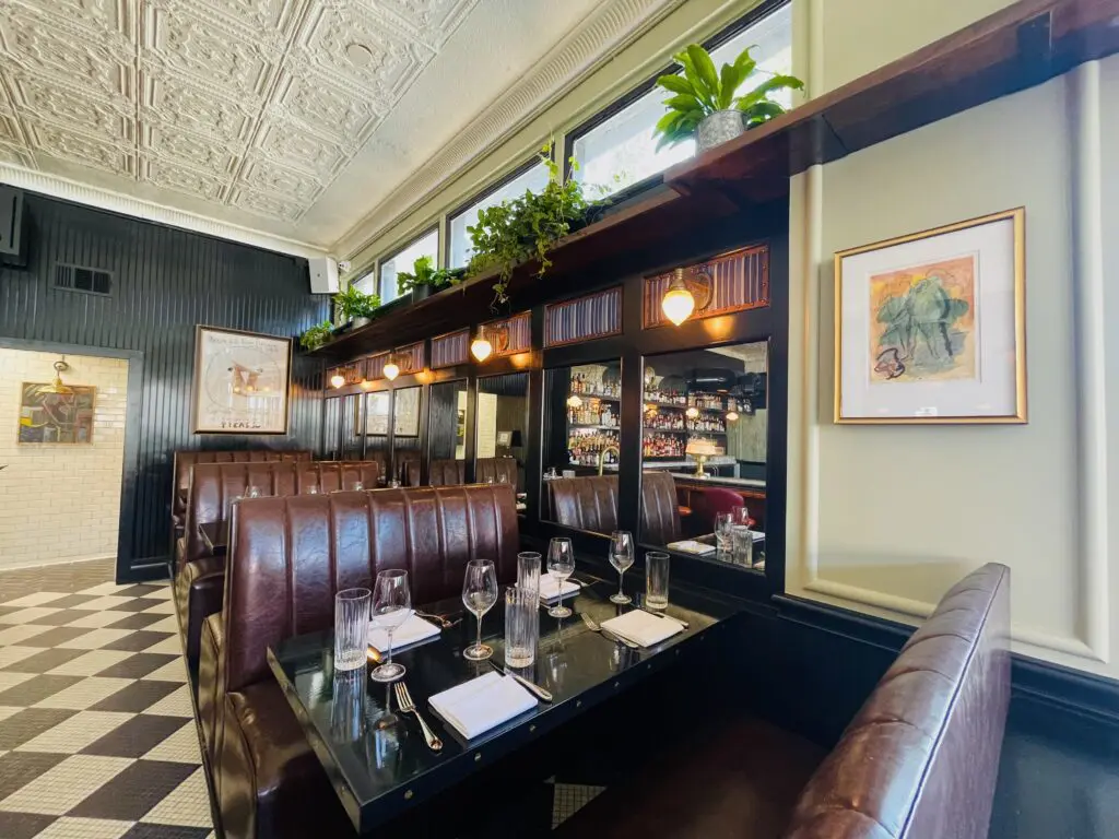Sconces, tin tile ceiling and plant shelves add layers of design details. (Photo by Courtney Dabney)