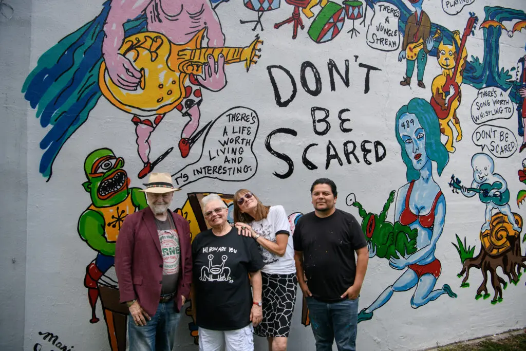 Redbud Arts Center president Gus Kopriva, executive director Tanya Peterson, Marjory Johnston, Carlos Alcaraz (Empyre) get together at the "Don't Be Scared" mural honoring the late artist Daniel Johnston. (Photo by Saranna Zhang/Kevin Zhang Photography)