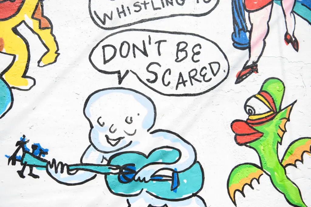 Details of the "Don't Be Scared" mural, featuring recreations of Daniel Johnston's cartoons and song lyrics (Photo by Saranna Zhang/Kevin Zhang Photography)