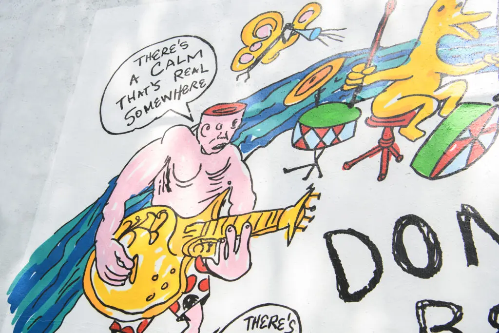Details of the "Don't Be Scared" mural, featuring recreations of Daniel Johnston's cartoons and song lyrics (Photo by Saranna Zhang/Kevin Zhang Photography)
