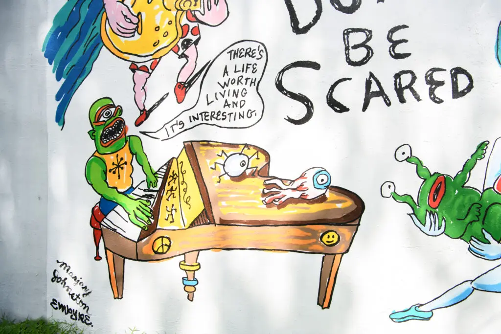 Details of the "Don't Be Scared" mural, featuring recreations of Daniel Johnston's cartoons and song lyrics (Photo by Saranna Zhang/Kevin Zhang Photography)