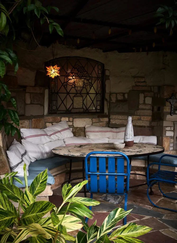 A banquette and table tucked into a grassy berm of Robert Bellamy's Old East Dallas home.  (Photo by Pär Bengtsson)