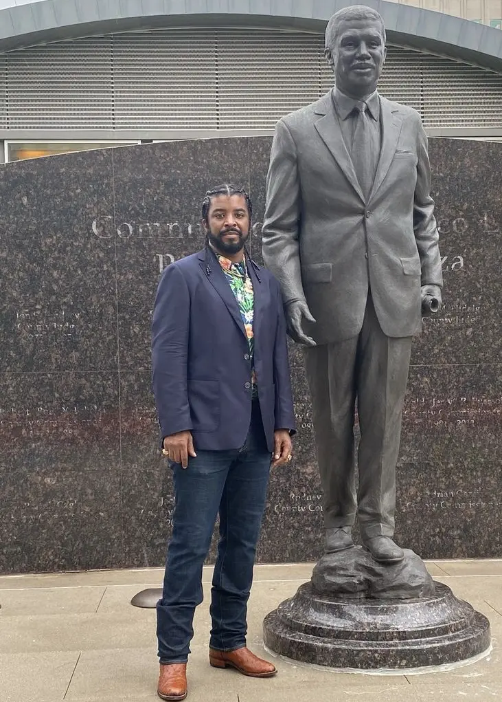 Artist El Franco Lee II stands next to a statue of his father, the late Harris County Precinct One commissioner El Franco Lee. The statue was unveiled in August 2022. It was designed and sculpted by Chas Fagan. (Courtesy El Franco Lee II)