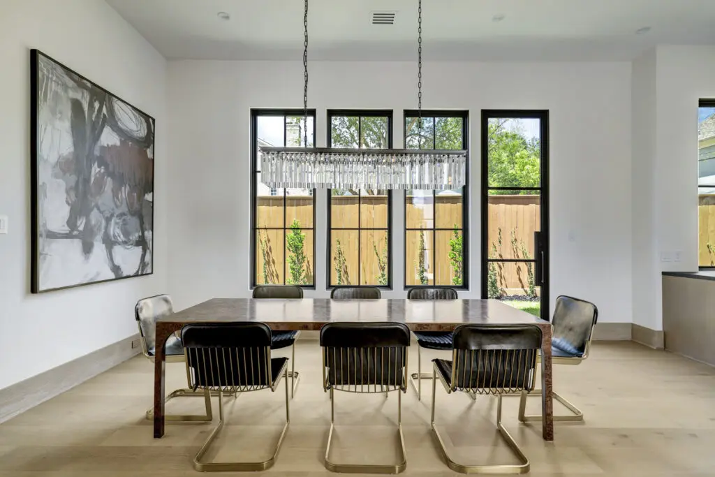 The dining room enjoys an abundance of light via the window system. (Photo by TK Images for Compass)