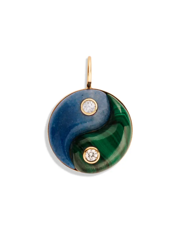 The ancient philosophy of yin and yang inspired this beautiful Retrouvaí pendant that features yellow gold, trolliete, and malachite. 