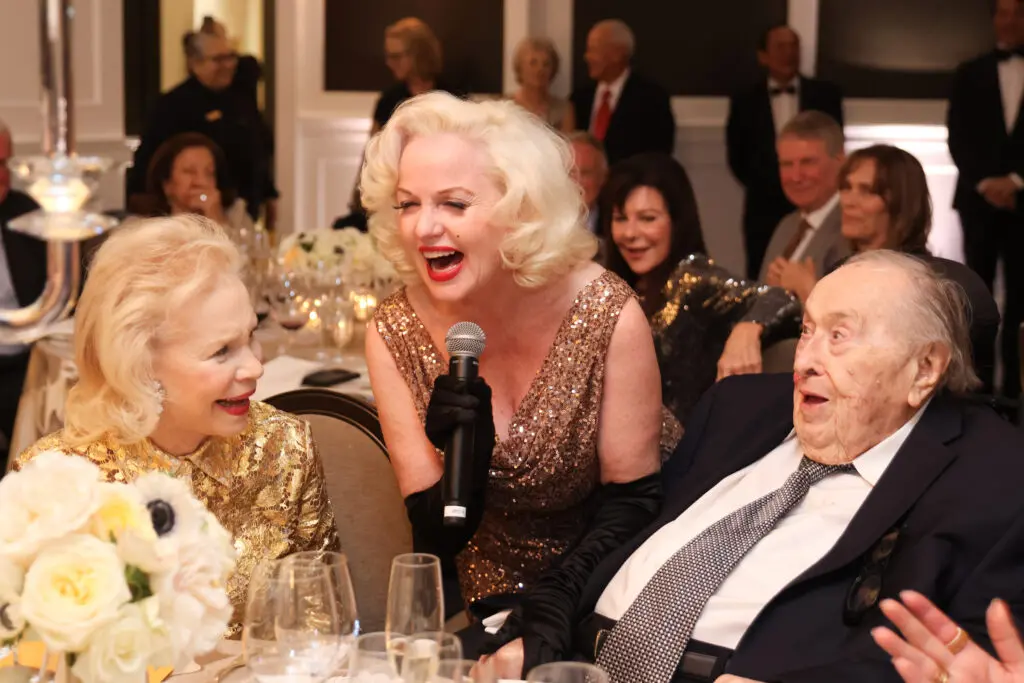 'Marilyn Monroe' entertains the honored couple at the Lynn & Oscar Wyatt birthday/wedding anniversary celebration at the Houston Petroleum Club. (Photo by Priscilla Dickson)