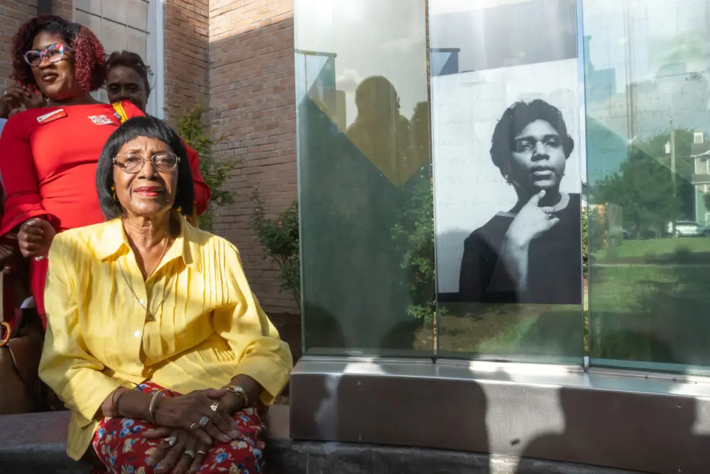 Rose Mary McGowan poses next to the image of her sister Barbara Jordan. The monument, located at the African American Library at the Gregory School, is the first in Houston dedicated to Jordan’s memory. (Photo by Ken Jones Photography/Dennis Rogers)