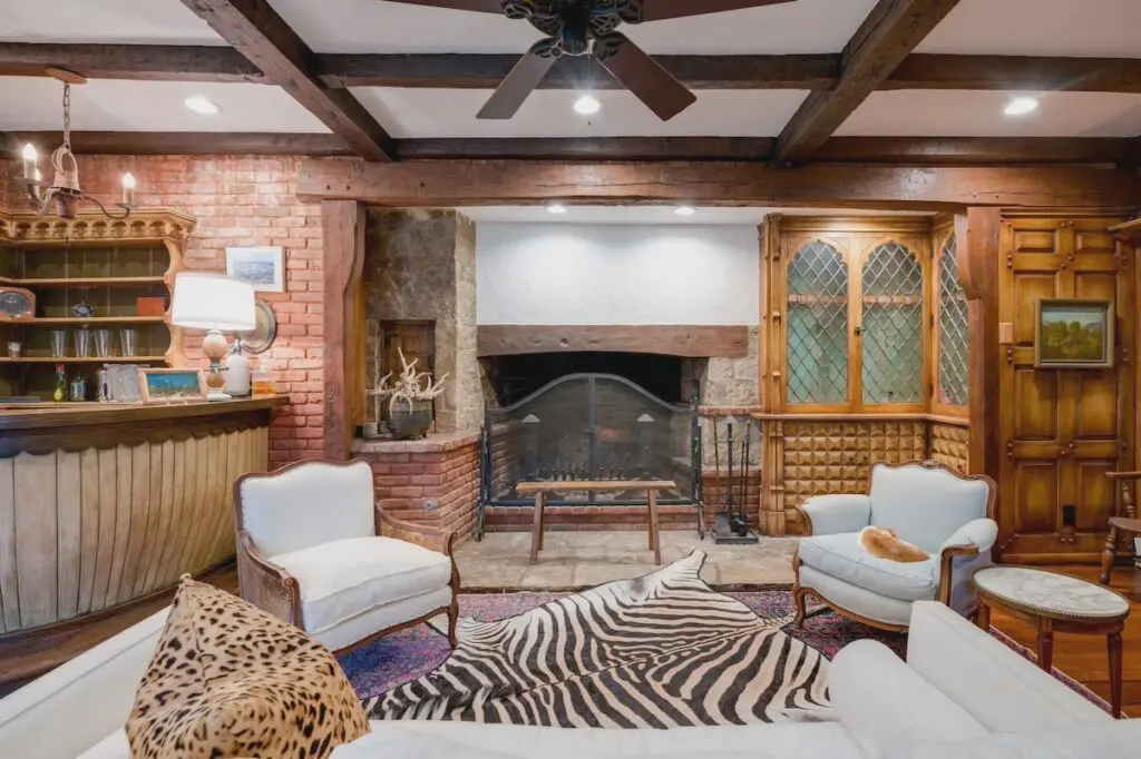 A barrel-shaped wet bar defines one of the living areas.