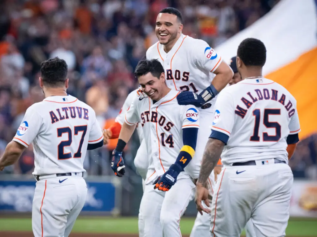 Yainer Diaz is so excited by Mauricio Dubon walking it off in the bottom of the ninth that he jumps on for a ride. (Photo by F. Carter Smith)