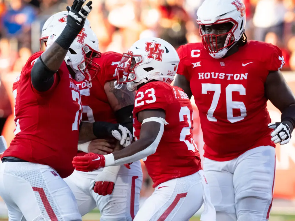 University of Houston's offensive line gets a kick out of true freshman running back Parker Jenkins.  (Photo by F. Carter Smith)