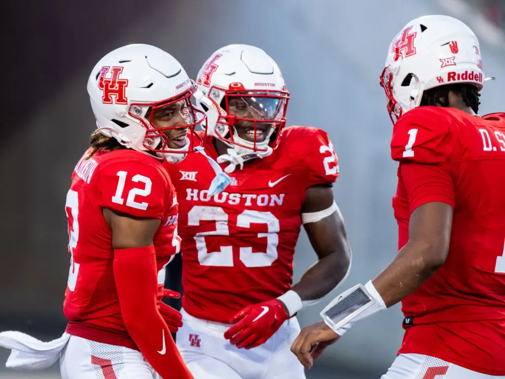 University of Houston receiver Stephon Johnson (No. 12) and Donovan Smith (No. 1) are all in on what freshman running back Parker Jenkins is doing. (Photo by F. Carter Smith)