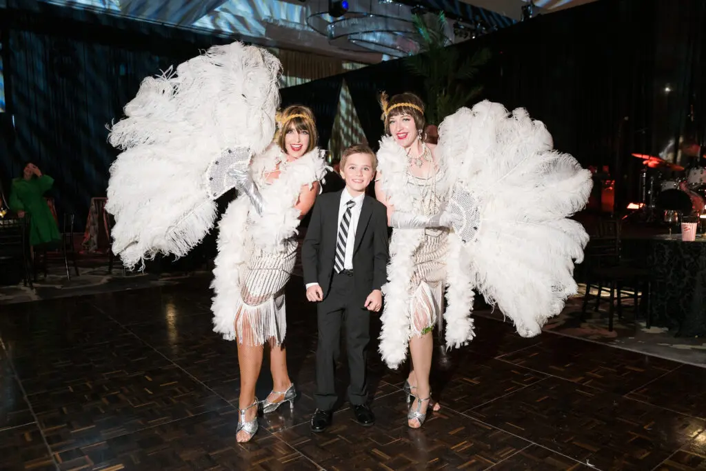Ten-year-old Kick Forester with dancers at Texas Heart Institute's 'The Supper Club' gala held at the Post Oak Hotel. (Photo by Daniel Ortiz)