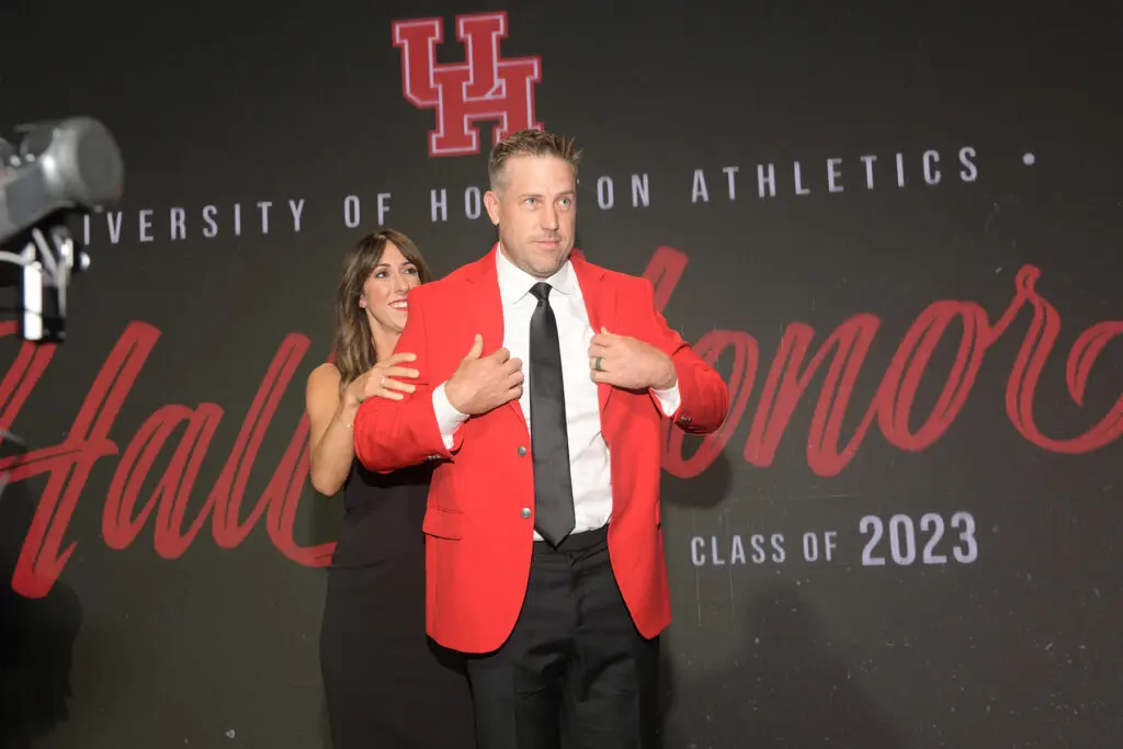 Kimberly Keenum presented her husband Case Keenum with his red UH Hall of Honor jacket. (Photo by Eddy Matchette/Courtesy UH Athletics)