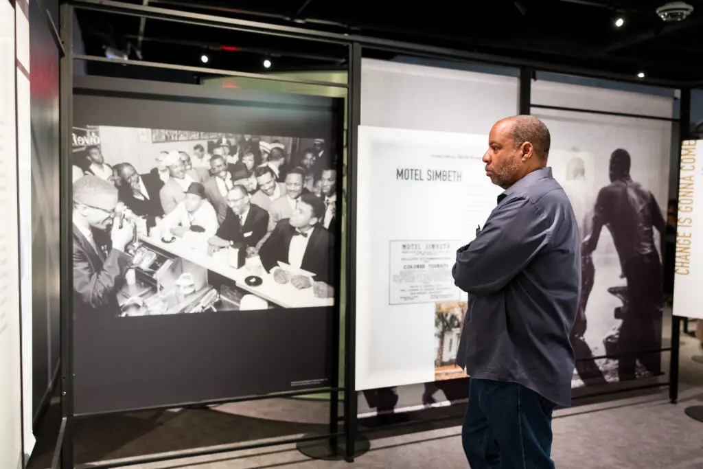 A guest studies 'The Negro Motorist Green Book' exhibition at Holocaust Museum Houston on view now through November 26. (Photo by Hung L. Truong)