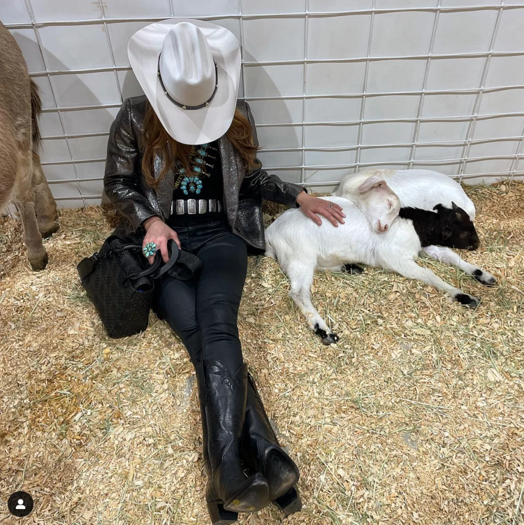 Kristina Somerville taking a break with friends in the Petting Zoo at the 2023 Houston Livestock Show and Rodeo. (Instagram photo)