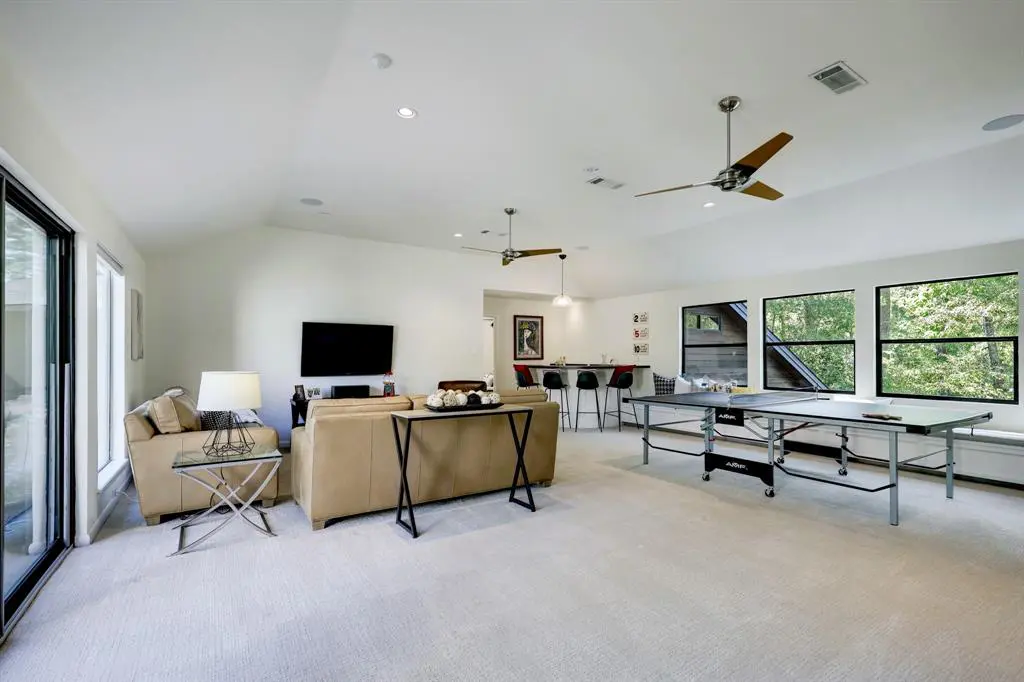 There are several spaces to enjoy upstairs at this Panther Creek home, with a massive game room, bar and balcony. Perfect for parties.