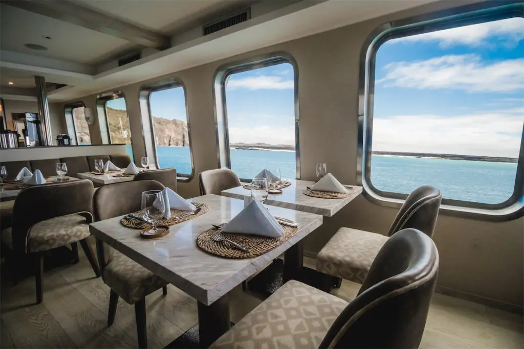 The elegant dining room features marble tabletops, with configurations for private or group dining. 
