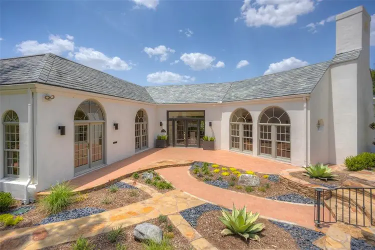 The modern new hardscape leads to the front entrance at a memorable Fort Worth mansion.