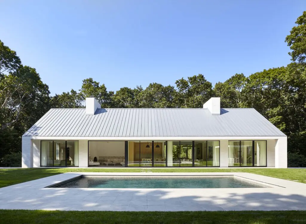 The south side of house in Southampton, designed by Sawyer | Berson, with a portico spanning its full width. The walls are handmade brick, the doors
and windows are anodized aluminum, and the roof is standing-seam zinc. (Photo by Joshua McHugh) 