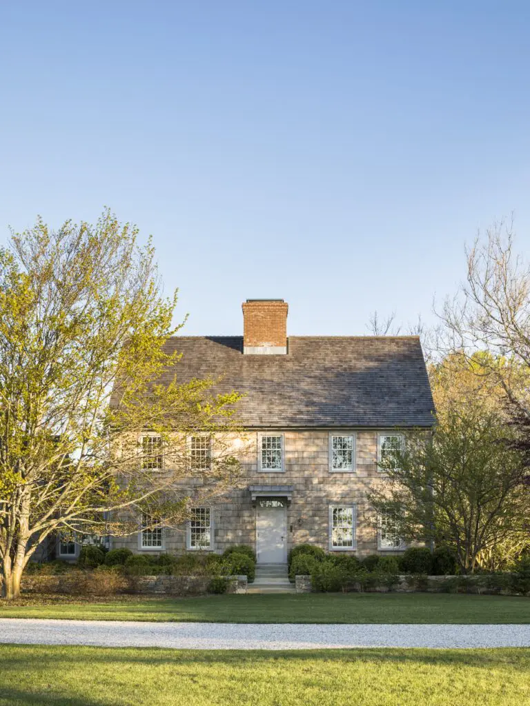 In restoring one of Suffolk County’s oldest structures, Peter Pennoyer used traditional wood shingles, reflecting mid-eighteenth-century building practices, and designed a new batten door and overhang inspired by a neighboring house of the same period. The sage-green paint for the window frames and door is historically based. (Photo by Eric Piasecki)