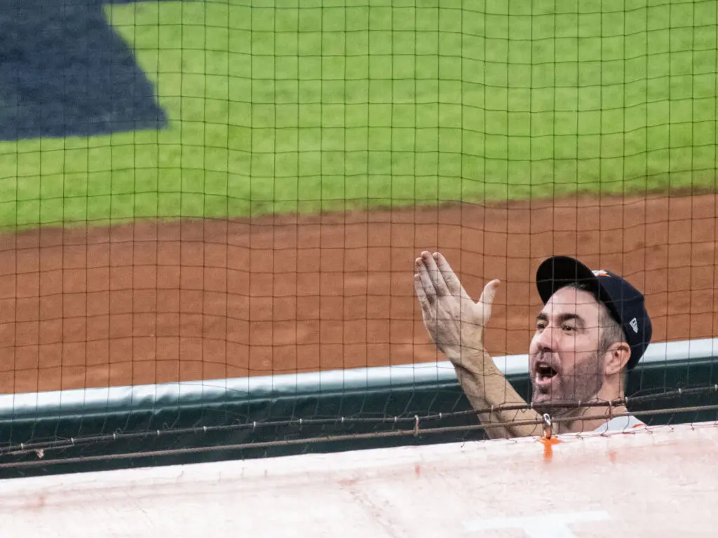 Justin Verlander waved up to Kate Upton and his daughter after another playoff win. (Photo by F. Carter Smith)