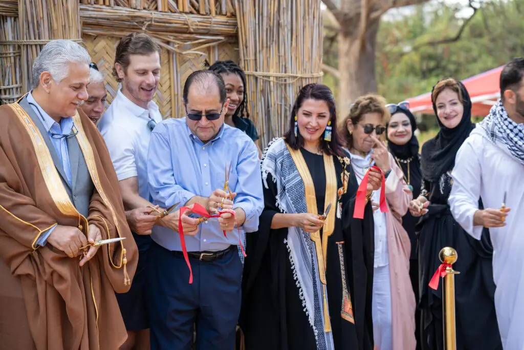 Members of the Iraqi community, and organizations such as the Arab American Educational Foundation joined together for the ribbon cutting of the mudhif.  (Photo by Henrich Perez)