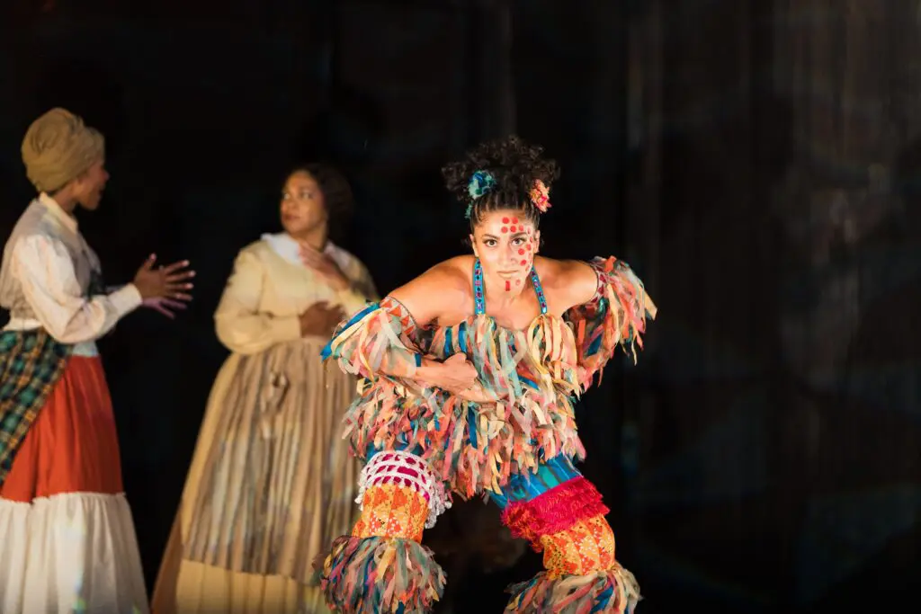 Urban Bush Women Dancer Bianca Leticia Medina (J'Nai Bridges and Janai Brugger in background) in the world premiere opera Intelligence. (Photo by Michael Bishop)