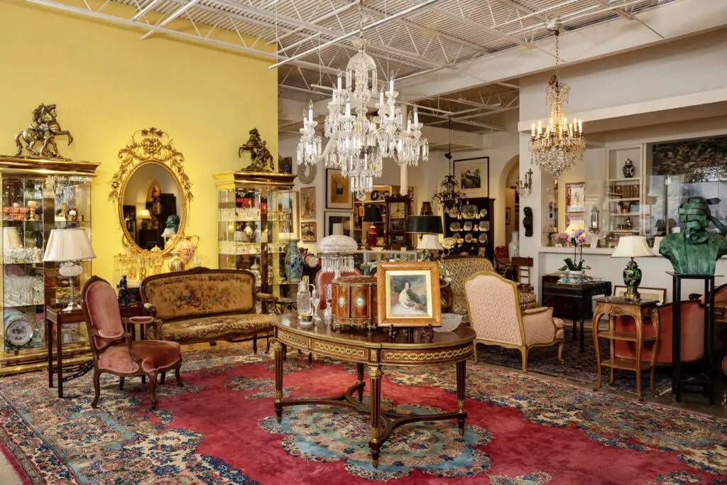 A view of the main room featuring art, antiques, lighting, and rugs (Photo by Jenny Antill Clifton)