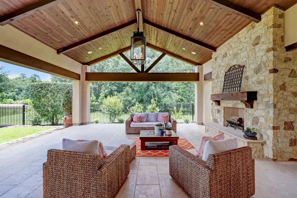 The covered patio outside living space is perfect for crisp evenings, complete with stone fireplace. 