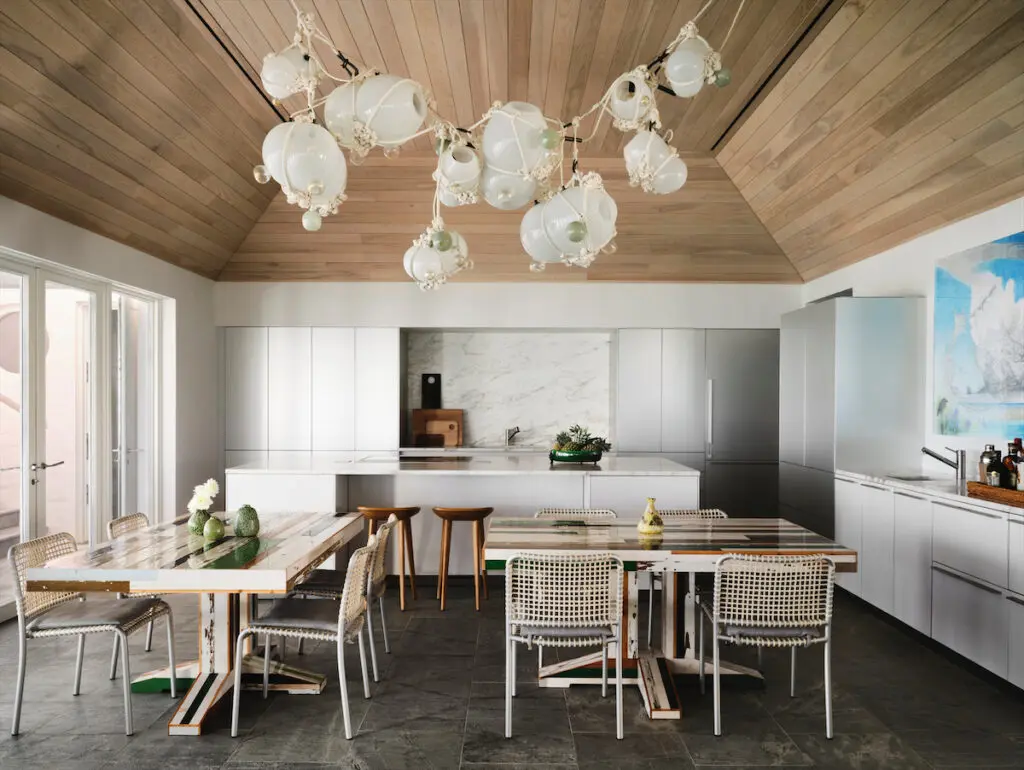 In the dining area, Lindsey Adelman’s Knotty Bubbles chandelier. Reclaimed wood dining tables by Dutch artist Piet Hein Eek. Gervasoni chairs from Scott + Cooner. (Photo by Douglas Friedman)