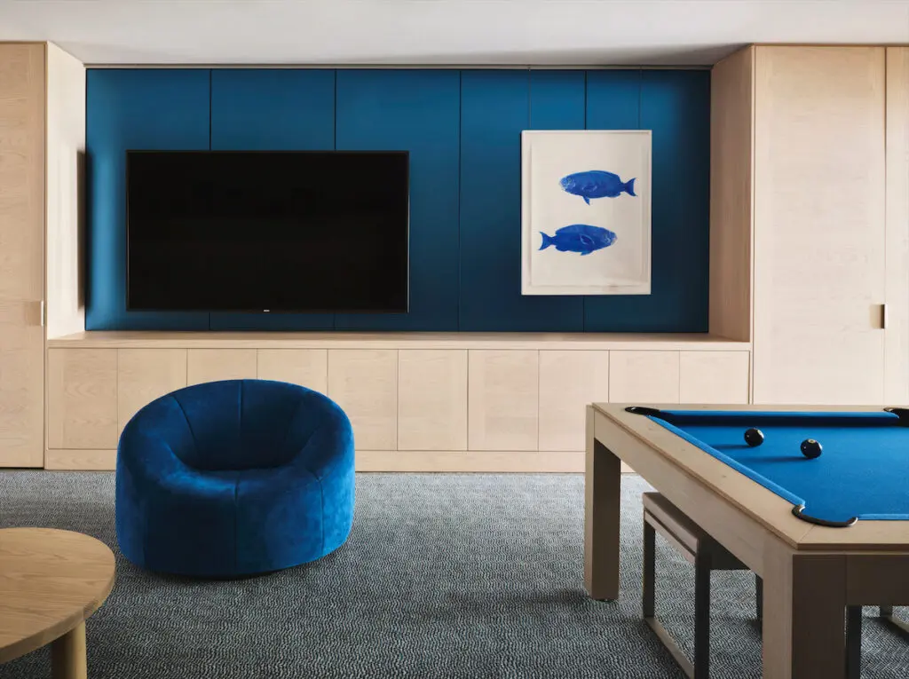 In the carriage house, a Ligne Roset swivel chair, pool table by Game Rooms by Design. Scott Kelley artwork. (Photo by Douglas Friedman)