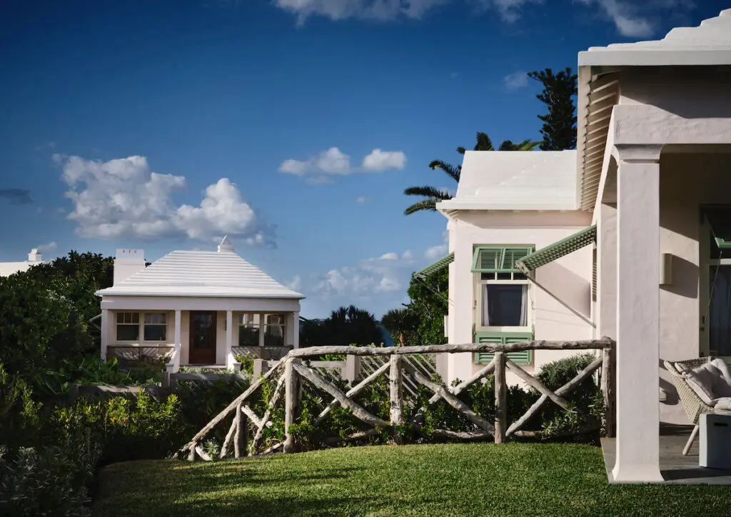 The carriage house, in distance. Railings and custom horizontal storm shutters were specially designed to provide uninterrupted views. (Photo by Douglas Friedman)