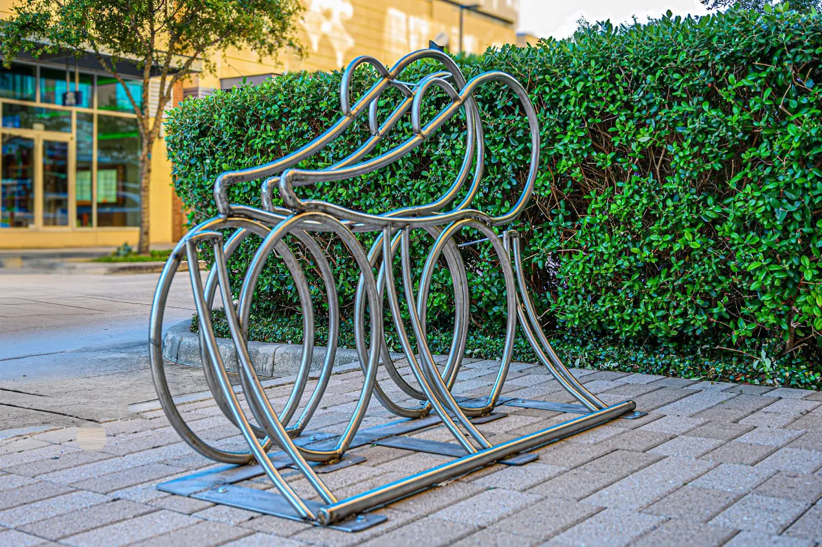 Three riders are represented in the "Faith, Hope and Love" bike rack from artist Robert Heintzelman. (Photo by Joan Tilton)