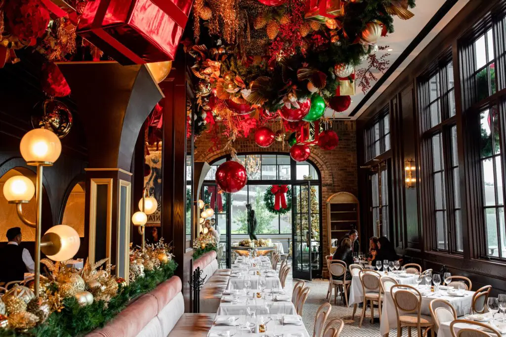 Inside, silk blossoms in shades of green, pink and violet dangle overhead, cleverly built upon an elaborate truss system that allows Berg to change the ceiling decor as the seasons change. (During the holidays, you’ll see a glittering array of Christmas ornaments.) Photo Kristen Gilliam.
