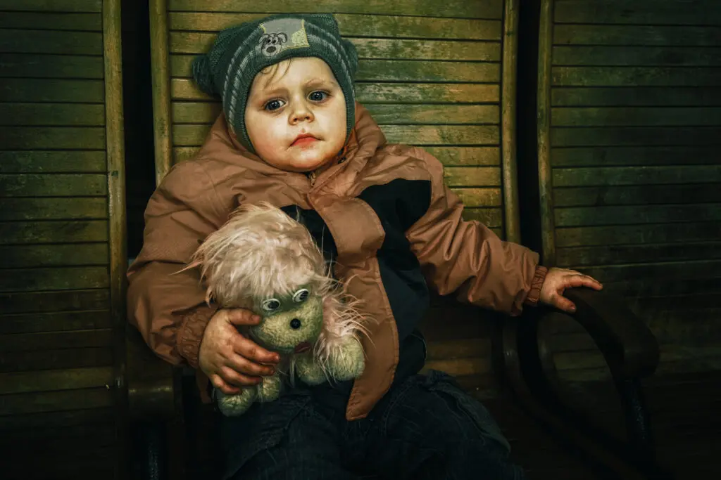Alena Grom's "Nikita," 2022. Nikita, his mother Svetlana, and his siblings were forced to flee the war in Krivoy Rog. They had nowhere to hide during air raids, and they felt in constant danger. Nikita's father stayed behind to join the military, even though he could have avoided mandatory service because he had three children. He didn't want to hide behind his children; he wanted to protect them. (Courtesy Ukrainian Association of Professional Photographers.) 