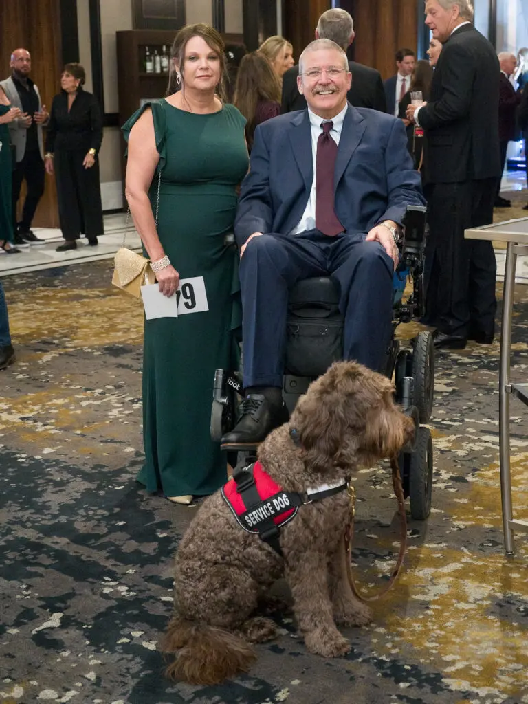 Alison Porter, Dr. Eugene Alford with Service Animal Sam at the Citizens for Animal Protection Celebrity Paws Gala (Photo by Daniel Ortiz)