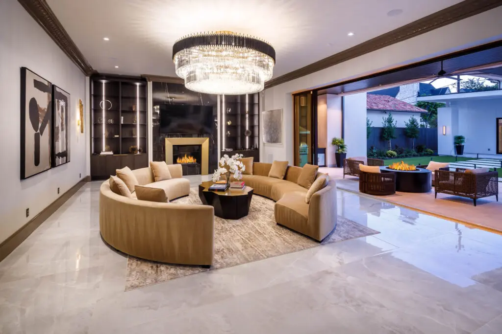 This living room view offers and elegant aesthetic. Both sliding doors open to reveal a spectacular loggia and fire pit. (Photo by Steve Chenn)