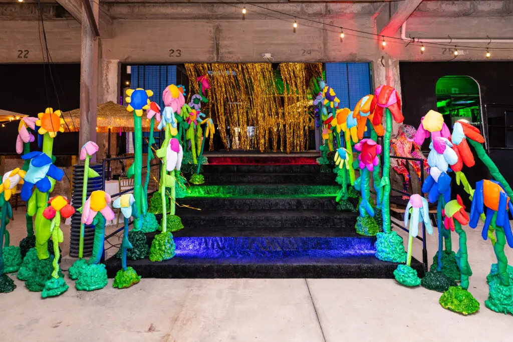 The flower-filled entrance was crafted by Falon Felscher at Orange Show Gala Where the Wild Things ART (Photo by Emily Jaschke and David DeHoyos)