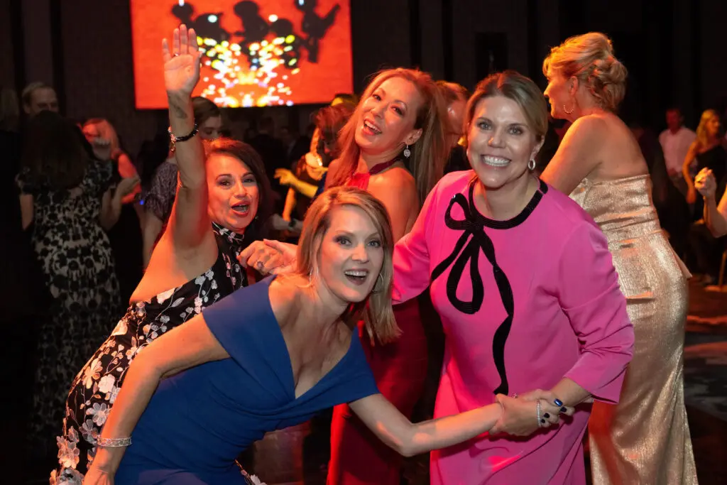 Terri Ebel, Molly Bobrow, Pat Mitchell, Claudia Kreisle dancing to the sounds of 
Skyrocket at the British American Foundation of Texas gala (Photo by Wilson Parish)