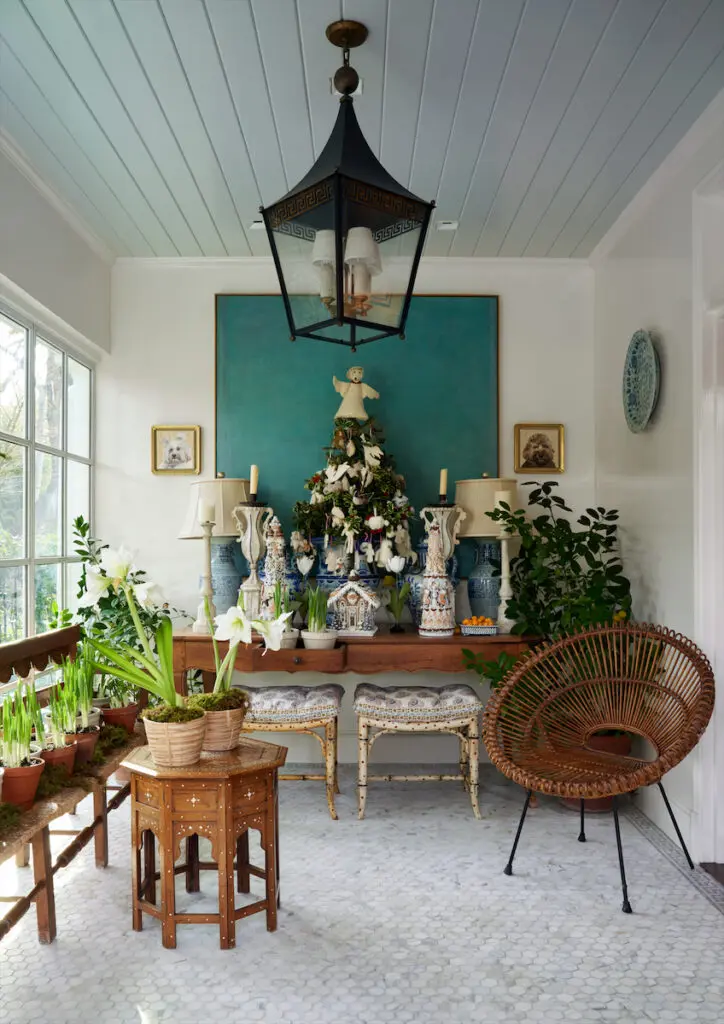 The foyer’s marble mosaic floor tiles are from Ann Sacks. Vintage wicker chair. Lemon and orange trees perfume the room. (Photo by Pär Bengtsson)