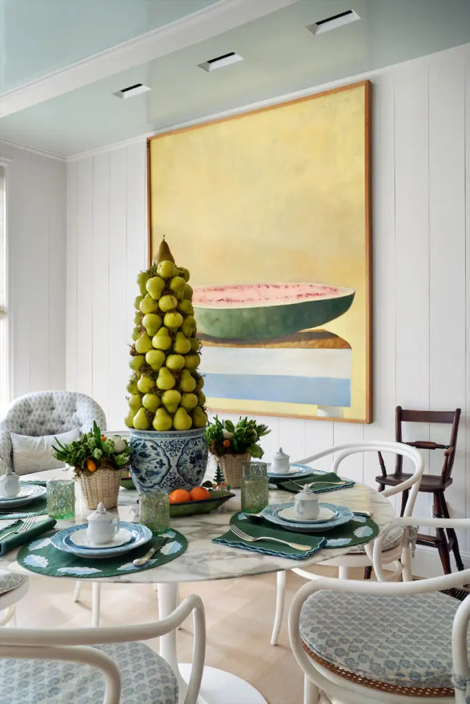 The breakfast nook's Eero Saarinen table is from Knoll, and Thonet chairs are from DWR. Linens by Elizabeth Lake. Plates from Anthropologie and Tory Burch. Mottahedeh pots de crème, colorful glasses from India. Julio Larraz painting. (Photo by Pär Bengtsson)